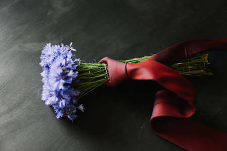 bouquet of cornflowers on a dark background. wedding details, bridal bouquet. wild flowersの写真素材
