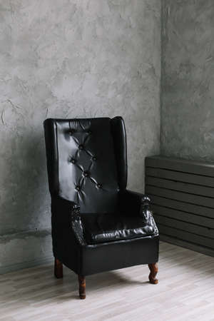 black leather chair against  gray wall background. minimalistic concept. Interior design.の写真素材