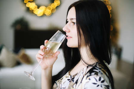 New Year's portrait of a girl with a glass of champagne.の写真素材