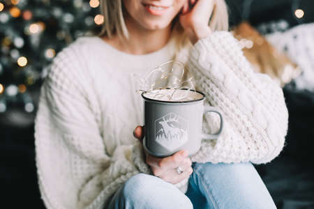 New Year portrait of a girl in beautiful interior. Girl with coffee in bed in the new year interior. Christmas and  New Year  conceptの写真素材