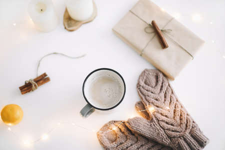 Christmas  New Year composition with coffee mug, gift, knitted mittens and decorations on white background. Flat lay, top view. Christmas, New Year,  Winter festive composition.の写真素材