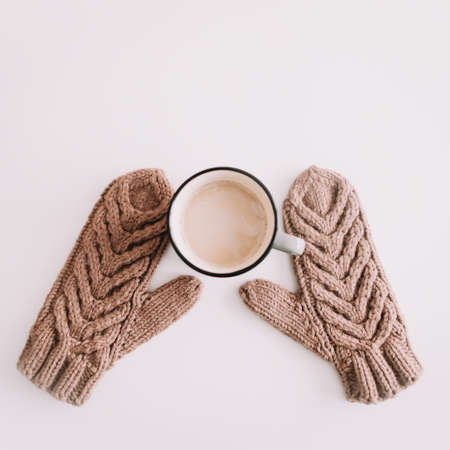 Christmas  New Year composition with coffee mug and knitted mittens isolated on white background. Flat lay, top view. Flatlay, top view, copyspaceの写真素材