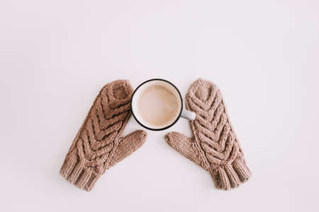 Christmas  New Year composition with coffee mug and knitted mittens isolated on white background. Flat lay, top view. Flatlay, top view, copyspaceの写真素材