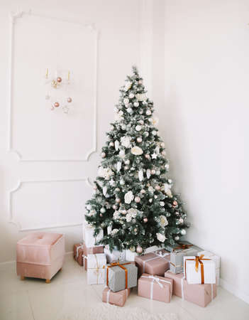 New Year festive interior. Christmas decorations. Holiday concept. Decorated Christmas tree with gifts.の写真素材