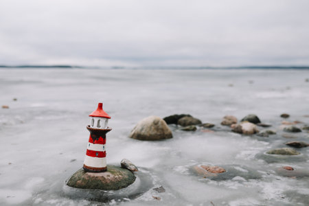Frozen winter sea with decorative lighthouse. Nautical lifestyle. Winter, Sea, Travel, adventure, holidays and vacation concept. Travel in 2021の写真素材