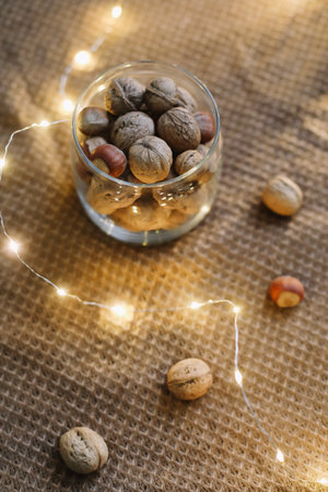 Mix of nuts in a jar on dark background. Walnuts and pine nuts. Top view. Copy space. Superfood, vegan, vegetarian food concept. Macro of walnut texture. selective focus. Healthy snack.の写真素材