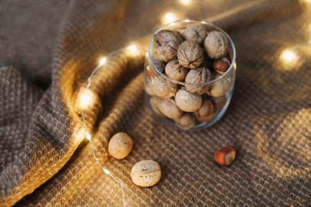 Mix of nuts in a jar on dark background. Walnuts and pine nuts. Top view. Copy space. Superfood, vegan, vegetarian food concept. Macro of walnut texture. selective focus. Healthy snack.の写真素材