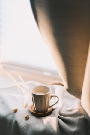 Cup of coffee with milk on beige textile. Still life morning breakfast concept.の写真素材