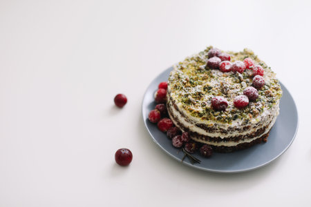 homemade cake with spinach and cream decorated with fresh cranberries on white table, diet breakfastの写真素材