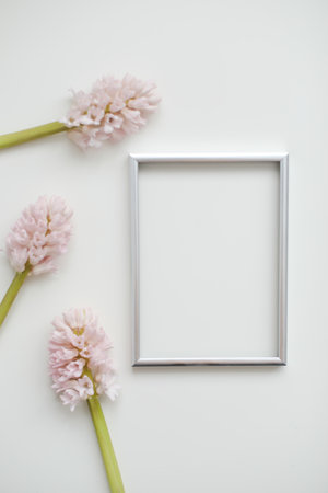 mockup with pink flowers and blank photo frame with copy space.の写真素材
