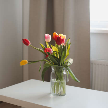 Bouquet of tulips in a vase on the tableの写真素材