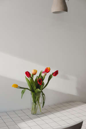 Bouquet of tulips in a vase on the tableの写真素材