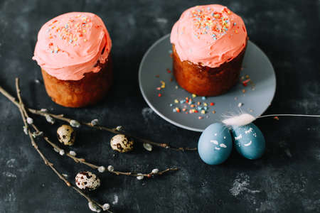 Easter cake, colorful eggs and willow branches on dark background. Happy Easter holiday conceptの写真素材
