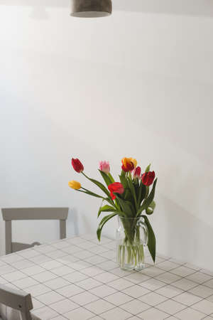 Bouquet of tulips in a vase on the table at home