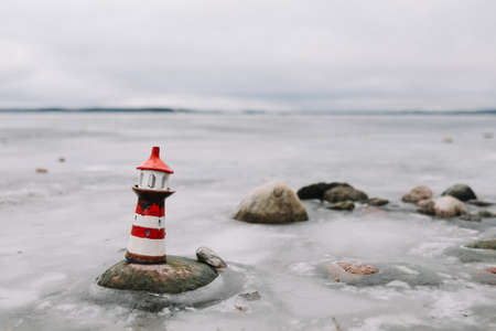 Frozen winter sea with decorative lighthouse. Nautical lifestyle. Winter, Sea, Travel, adventure, holidays and vacation conceptの写真素材