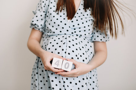 40 weeks of pregnancy. Pregnant woman touching belly. Happy woman pregnancy, maternity, body care. Expecting an upcoming babyの写真素材