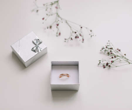 Golden ring and jewelry box and flowers. Wedding, Love, Valentines day, Happy Birthday, Proposal of marriage conceptの写真素材