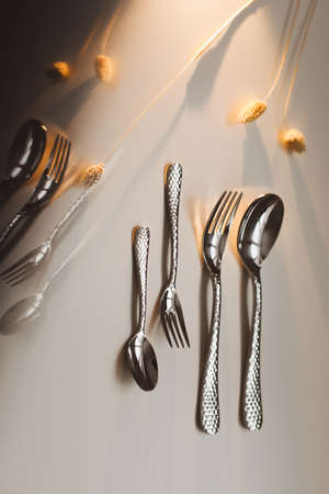 silver stainless cutlery on white background isolated with reflectionsの写真素材