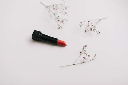 Red lipstick with flowers on white backgroundの写真素材