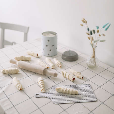 homemade baking. wooden rolling pin with dough on the kitchen tableの写真素材