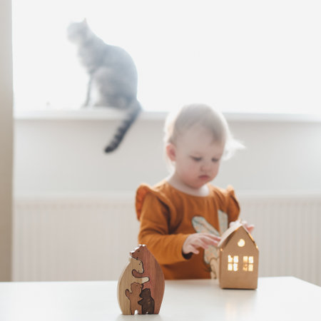 Little girl playing with eco-friendly wooden toys. Home activities for kidsの写真素材