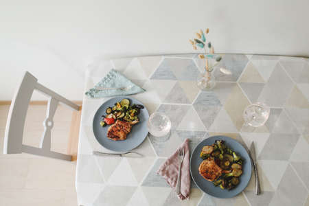 Table set on dinning table at home. Grilled steak and vegetablesの写真素材