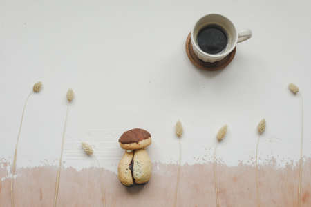 Cake mushroom and a cup of hot coffee on the table top view. Appetizing cake. Cookie and coffeeの写真素材