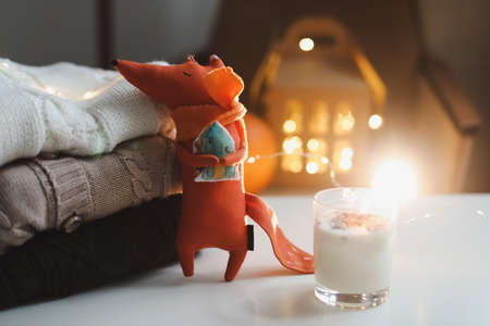 Autumn cozy still life with toy, candles and leaves. Cozy fall house decor, Thankgiving concept. Flat lay, hygge styleの写真素材