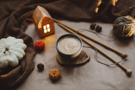 Autumn still life details in cozy home interior with a cup, candles, plaid. Hygge home decor....