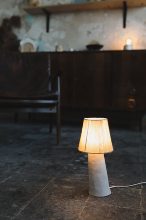 Stylish burning night lamp on table indoors. Light electric for interior homeの写真素材