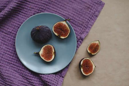 ripe fresh figs and purple textiles on rustic background, flatlay, overhead viewの写真素材