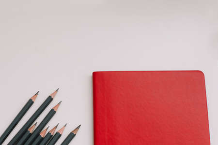 Back to school concept, school and office supplies, top view of notebook and pencils on white...