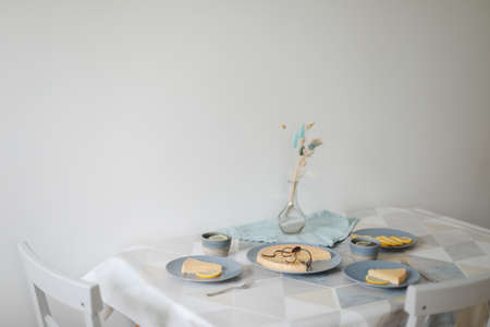 Breakfast with a lemon pie on plate with tea set and lemonsの写真素材