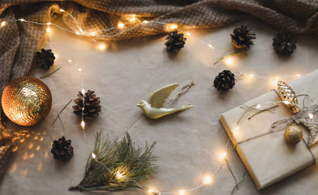 Christmas composition. Gift, fir tree branches, balls on craft paper background. Christmas, winter, new year concept. Flat lay, top view, copy spaceの写真素材