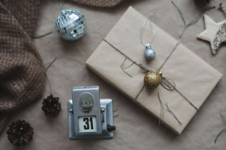 Christmas composition. New Year eve. December 31 on calendar on a craft paper background with spruce branches and a glowing garland. New years date. Flat lay, top viewの写真素材