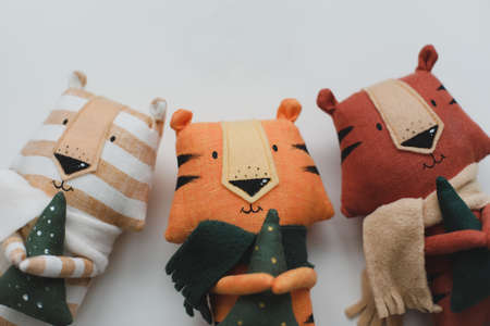 Handmade funny small tiger toys, symbol of new 2022 on white background. New Year 2022 concept