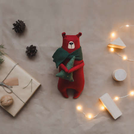 Christmas composition. Toy bear, a gift, fir tree branches and decorations. Christmas, winter, new year concept. Flat lay, top view, copy spaceの写真素材