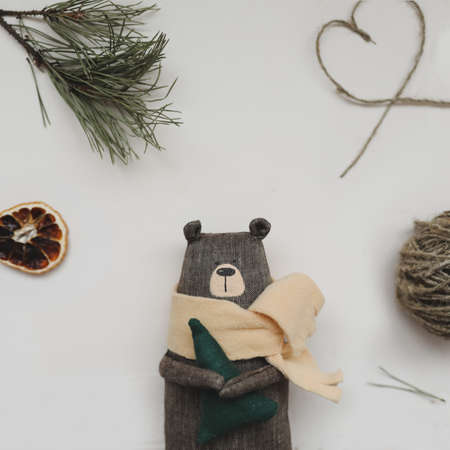 Christmas composition. Toy bear, a gift, fir tree branches and decorations. Christmas, winter, new year concept. Flat lay, top view, copy spaceの写真素材