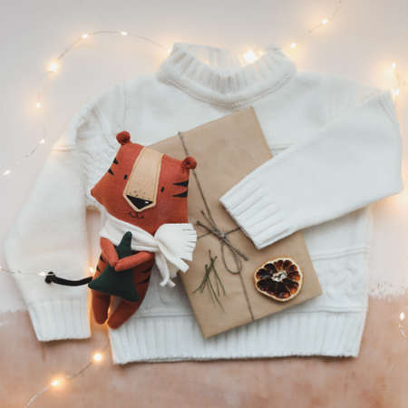 Christmas composition with a tiger toy, symbol of new 2022, a gift, fir tree branches and decorations. Christmas, winter, new year concept. Flat lay, top viewの写真素材