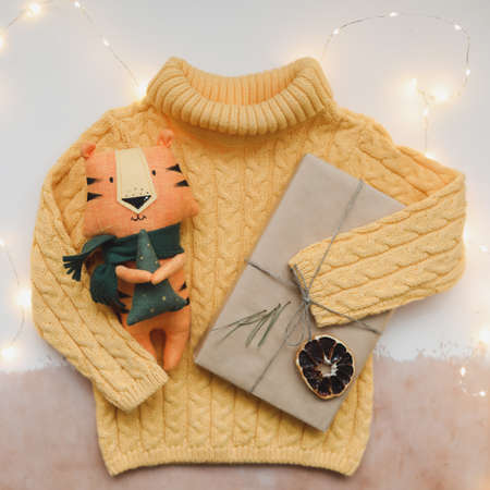 Christmas composition with a tiger toy, symbol of new 2022, a gift, fir tree branches and decorations. Christmas, winter, new year concept. Flat lay, top viewの写真素材