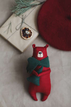 Christmas composition. Toy bear, a gift, fir tree branches and decorations. Christmas, winter, new year concept. Flat lay, top view, copy spaceの写真素材