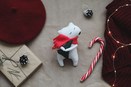 Christmas composition. Toy bear, a gift, fir tree branches and decorations. Christmas, winter, new year concept. Flat lay, top view, copy spaceの写真素材
