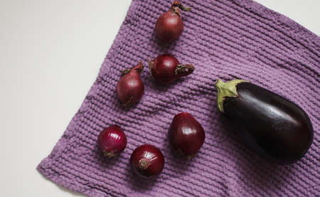 Red onion and kitchen towel isolated on white. autumn harvest, fresh vegetables