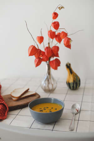 Hot healthy vegetarian pumpkin cream soup with seeds on the tableの写真素材