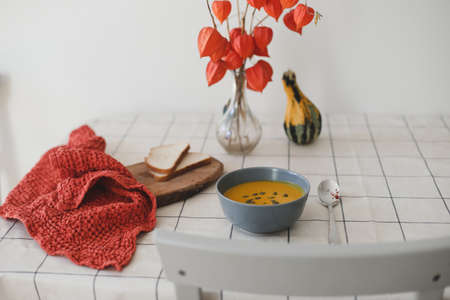 Hot healthy vegetarian pumpkin cream soup with seeds on the tableの写真素材