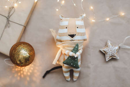 Christmas composition with a tiger toy, symbol of new 2022, a gift, fir tree branches and decorations. Christmas, winter, new year concept. Flat lay, top viewの写真素材