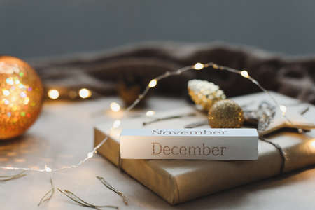 Christmas composition. Gift, fir tree branches, balls on paper background. Christmas, winter, new year concept. Flat lay, top view, copy spaceの写真素材