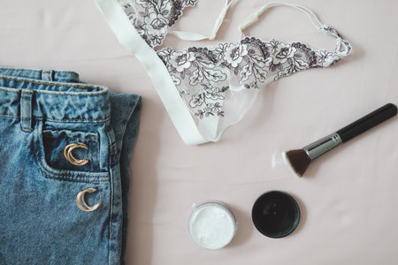 Flat lay composition with women underwear, bra, jeans, cosmeticsの写真素材