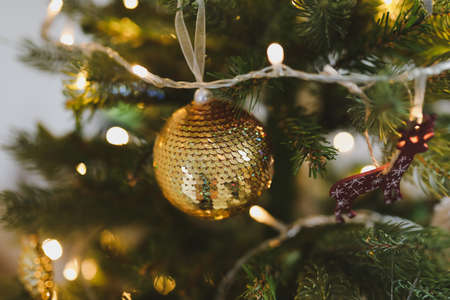 New Year mood 2022. Sparkling Christmas tree with balls and decorationsの写真素材