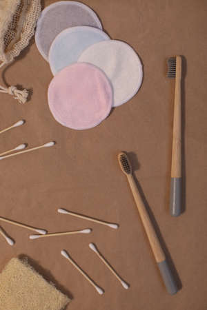 plastic free and eco friendly products in household, wooden toothbrushes, cotton swabs on craft paper background top viewの写真素材
